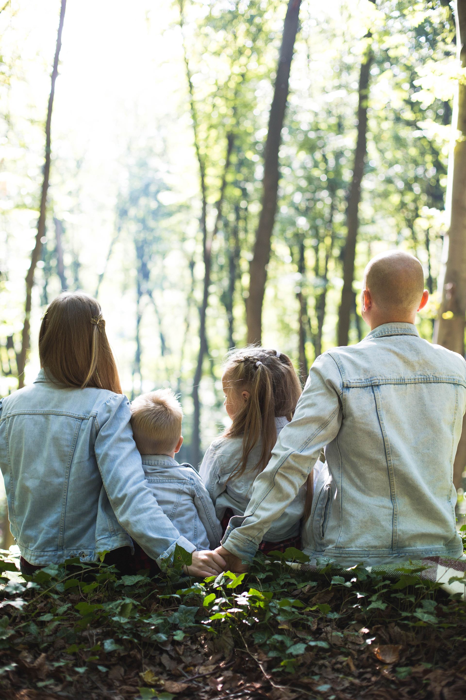 a group of people standing next to a tree